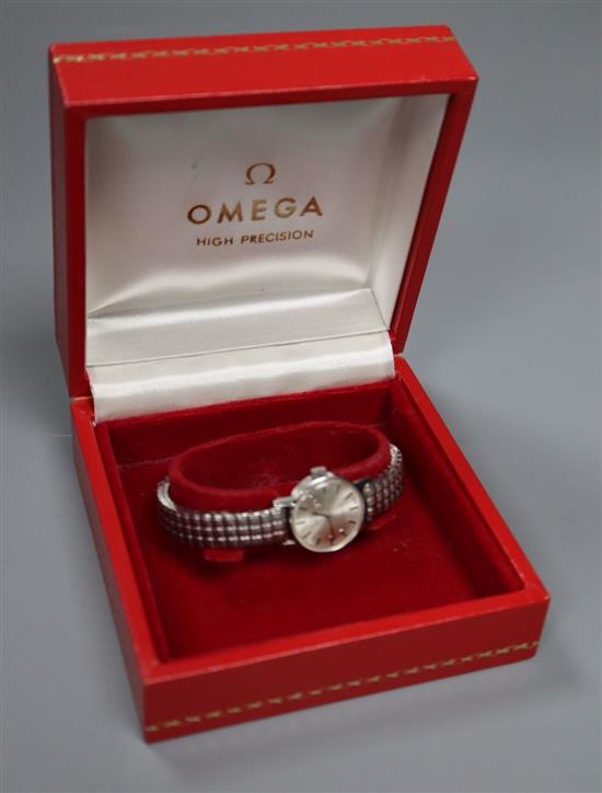 A ladys stainless steel Omega manual wind wrist watch, on associated flexible strap,